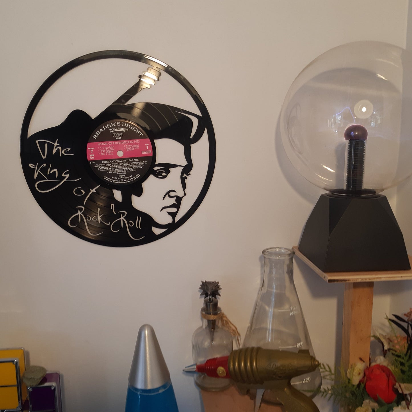 Vinyl record wall art with a silhouette design on a white surface.