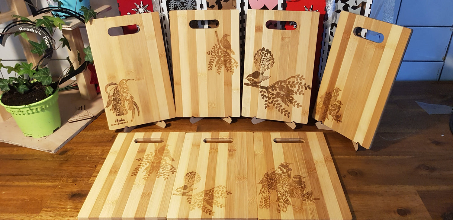 Collection chopping and serving boards with kiwiana designs