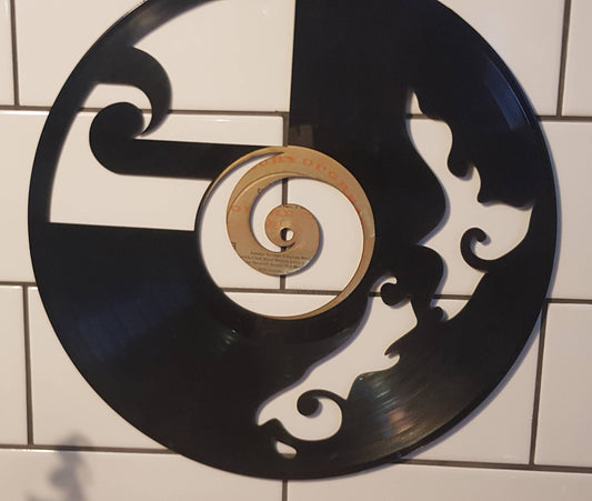 Decorative wall art made from a vinyl record with a koru design and New Zealand Map