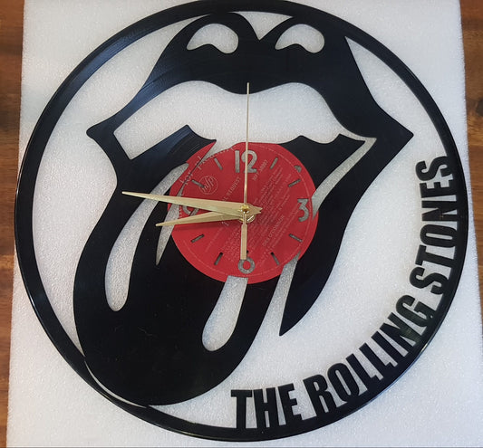 Vinyl Wall clock with Rolling Stones logo on a wooden surface