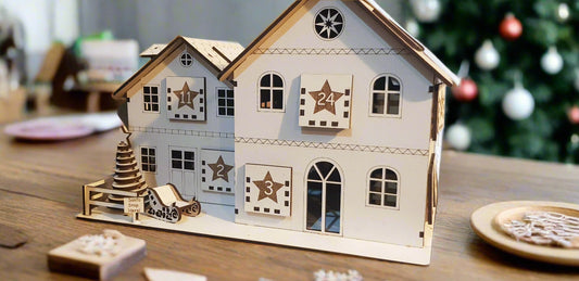 Decorative house-shaped clock with star and number 24 design on a wooden surface.