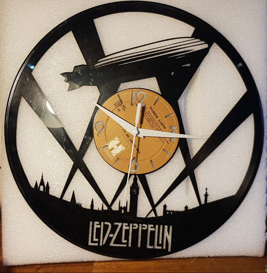 Vinyl record clock with Led Zeppelin design on a tiled wall.