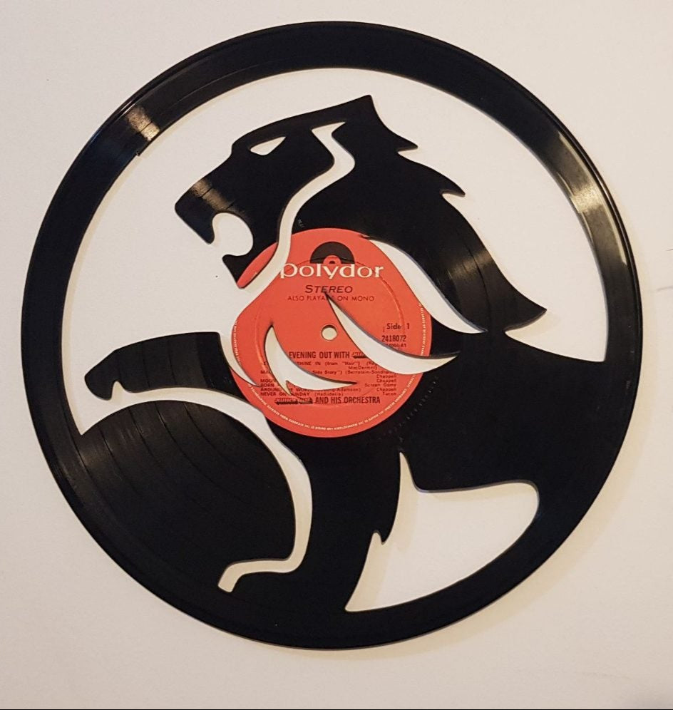 Vinyl record wall art with a holden lion design on a white wall.