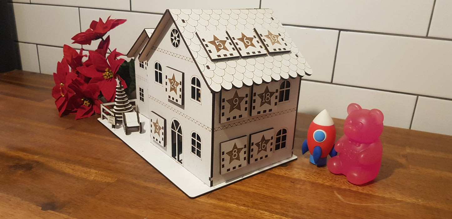 Small model house with decorative elements on a wooden surface